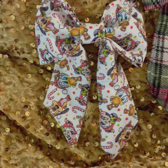 Three colorful hair bows in Christmas Pals, plaid and Snow Friends on a glittery gold background