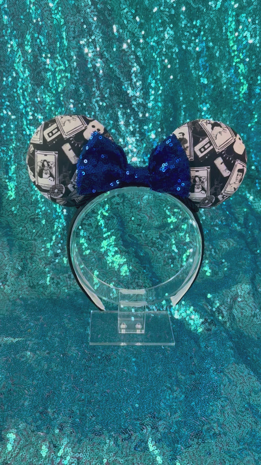 Handmade and ready to ship Stranger Things Collage Mouse ears with a blue sequin bow, black twisted trim on a black poly cotton universal sized headband. 