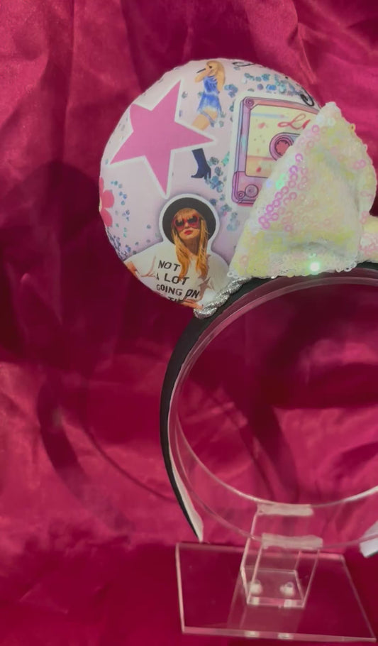 Mouse ears Headband with decorative elements. Shown on a pink glittery background