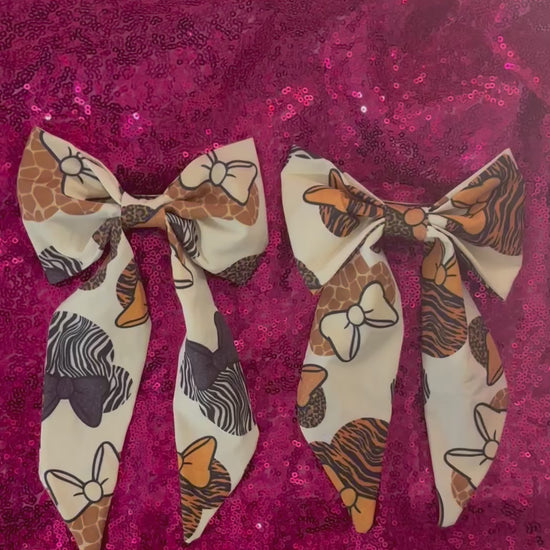 Two handmade and ready to ship fabric bows with animal print patterns in French Tailed Bows with barrette backings. 