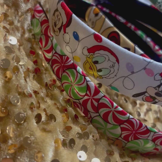 Set of Christmas-themed fabric items including headbands and keychains on a gold sequin background