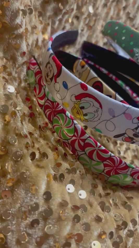 Set of Christmas-themed fabric items including headbands and keychains on a gold sequin background