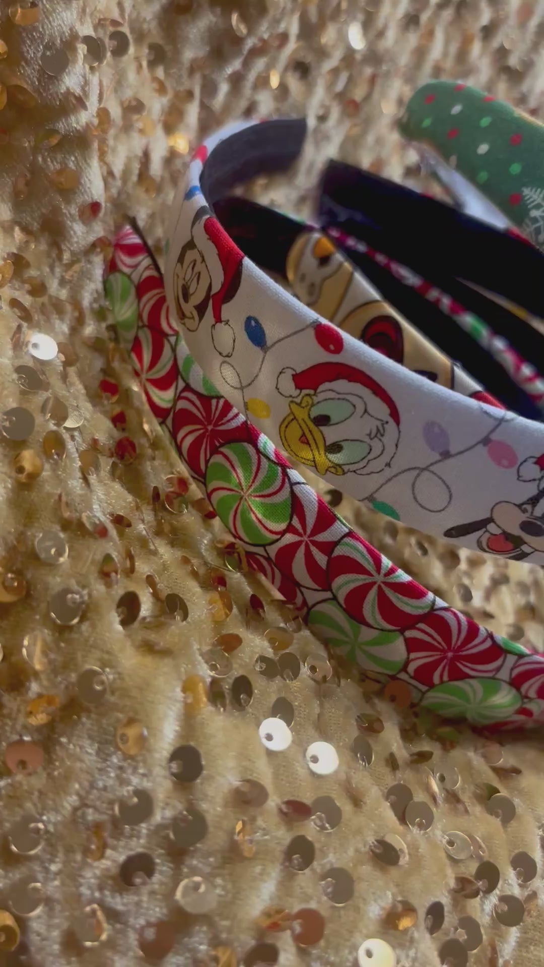 Set of Christmas-themed fabric items including headbands and keychains on a gold sequin background