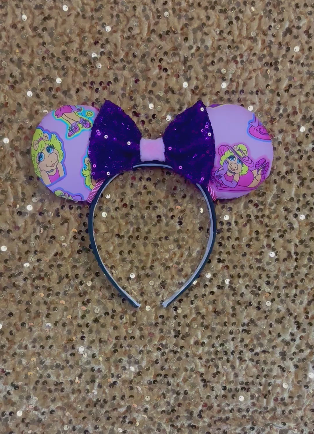 Handmade and ready to ship Piggy mouse ears. Miss Piggy fabric is on the front and the back. On a universal sized black poly fabric headband. With a purple sequin with pink soft middle on the bow. 