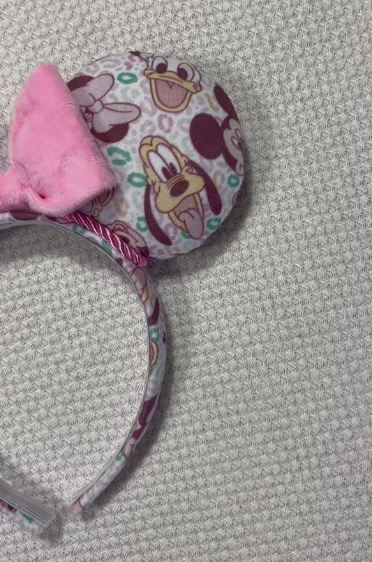 Pink and Leopard print with the fab 5 Mouse ears headband with a bow on a textured gray background