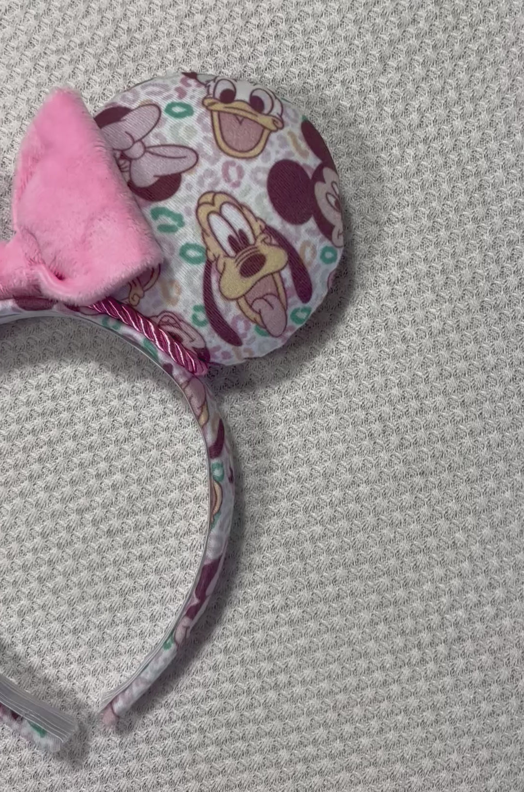 Pink and Leopard print with the fab 5 Mouse ears headband with a bow on a textured gray background