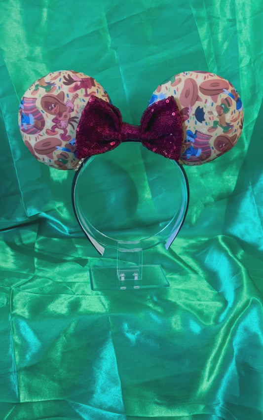 Handmade and ready to ship. These are perfect for Epcot. Three Caballero themed with a maroon sequin bow on a headband making mouse ears. Shown on a green background.