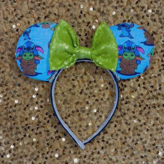 Handmade and ready to ship small friend aka Stitch and Baby Yoda Mouse ears with a lime green sequin bow. Of course, you can request any bow in sequin if you prefer and I will attach it. Shown on a gold sequin background.
