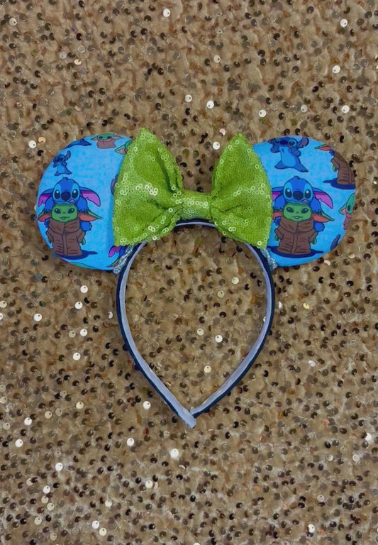 Handmade and ready to ship small friend aka Stitch and Baby Yoda Mouse ears with a lime green sequin bow. Of course, you can request any bow in sequin if you prefer and I will attach it. Shown on a gold sequin background.