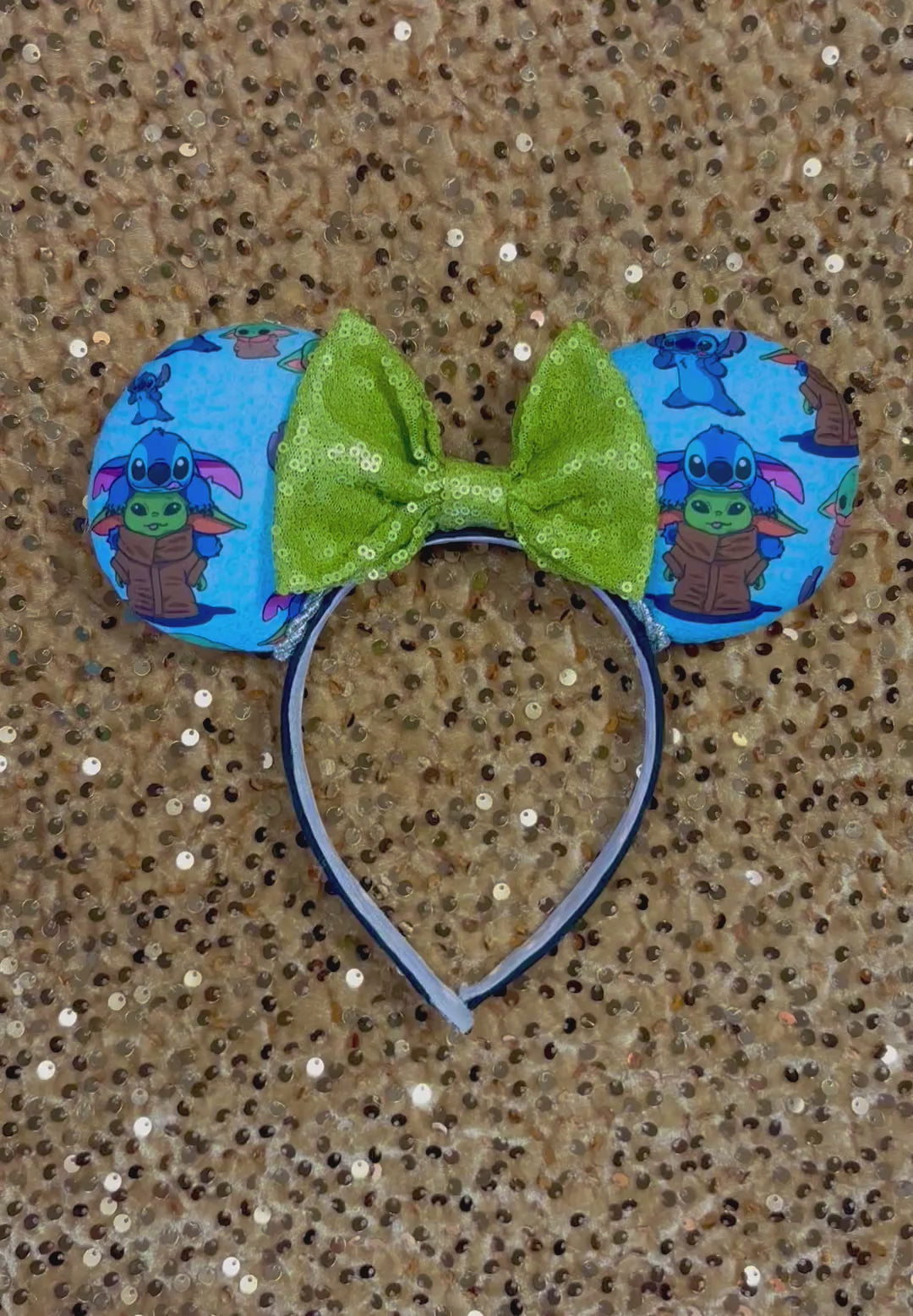 Handmade and ready to ship small friend aka Stitch and Baby Yoda Mouse ears with a lime green sequin bow. Of course, you can request any bow in sequin if you prefer and I will attach it. Shown on a gold sequin background.