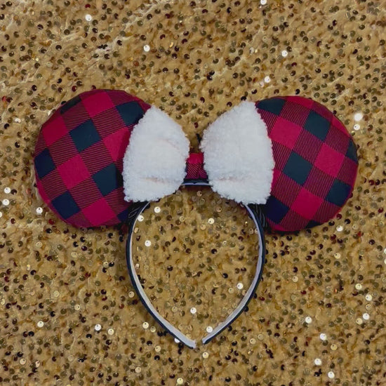 Handmade and ready to ship Buffalo Plaid mouse ears on both the front and back. On a black headband that is universal sized. The set has an off-white soft bow with buffalo plaid middle. Item is shown on a gold sequin background.