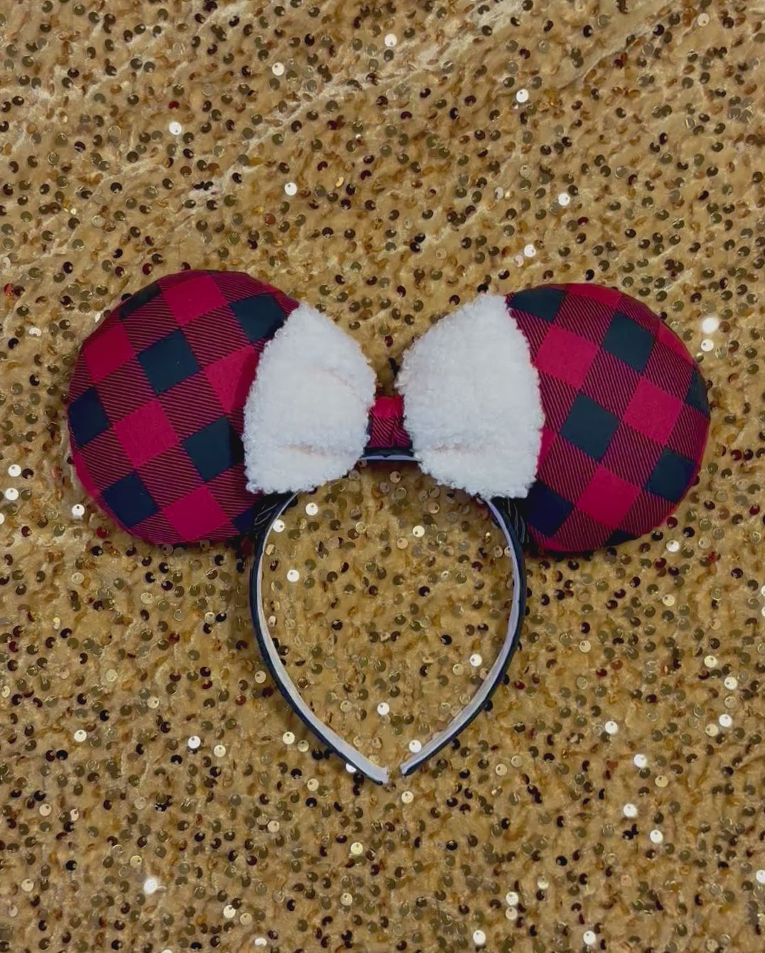 Handmade and ready to ship Buffalo Plaid mouse ears on both the front and back. On a black headband that is universal sized. The set has an off-white soft bow with buffalo plaid middle. Item is shown on a gold sequin background.