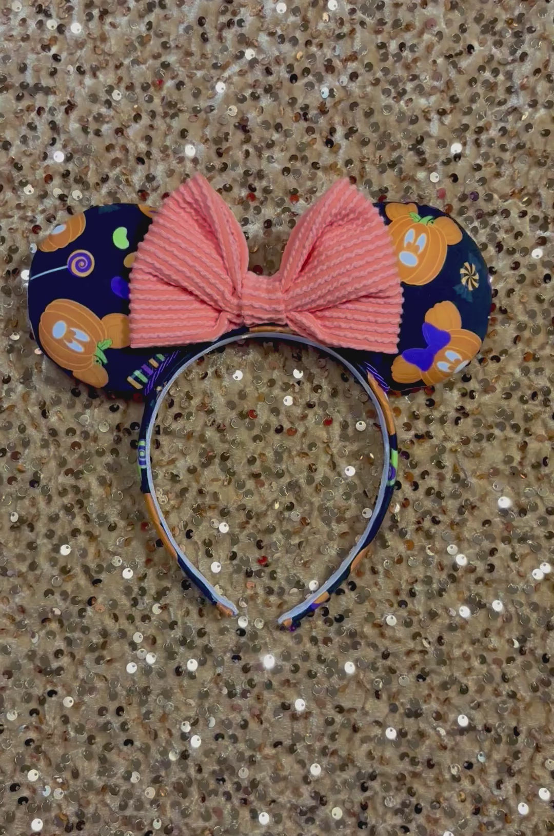handmade mouse ears with halloween boo to you fabric on ears and the headband.  Orange waffle print bow