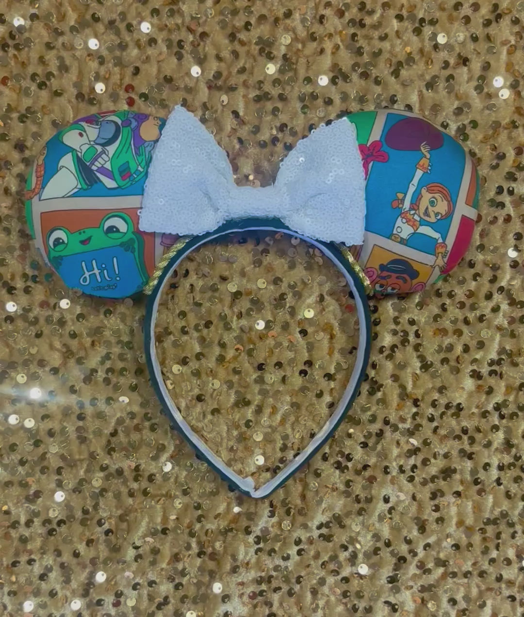 Handmade and ready to ship TS5 Inspired mouse ears. The character fabric is on the front and the back. On a universal sized black poly fabric headband. With a white sequin bow.