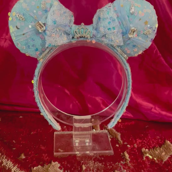 Handmade and ready to ship blue sequin mouse ears headband inspired by Cinderella with tulle and silver gemstones with a crown charm middle and rhinestone trim along inner ears.