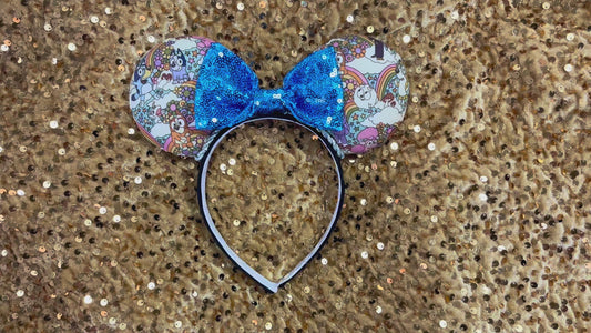 Mouse ears with a blue bow and colorful floral pattern with Bluey and friends on a gold background