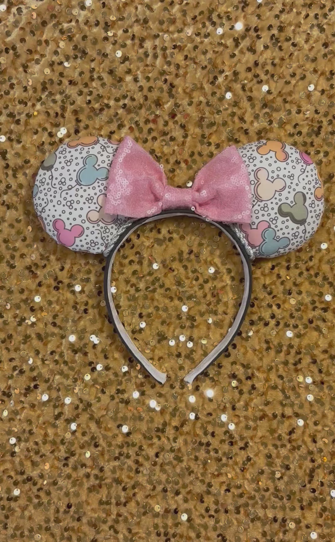 Handmade and ready to ship Mouse ears mouse balloons with a light pink sequin bow. Perfect for Main Street. Shown on a gold sequin background.