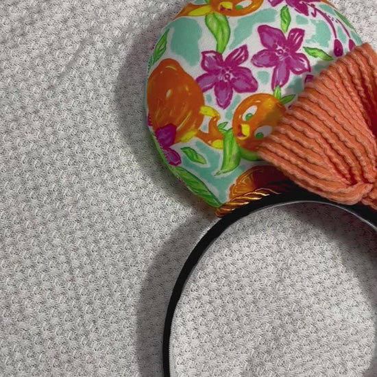 Pink, White, Blue and of course Orange on these handmade and ready to ship Orange Bird themed mouse ears with an orange waffle bow. Shown on a white background.