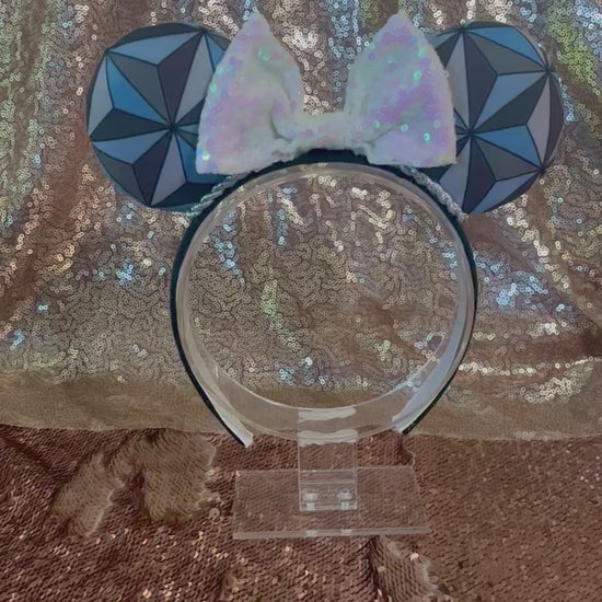Handmade and ready to ship Mouse ear headband with a geometric design inspired by Spaceship Earth ride and a white iridescent bow on a universal sized black headband.