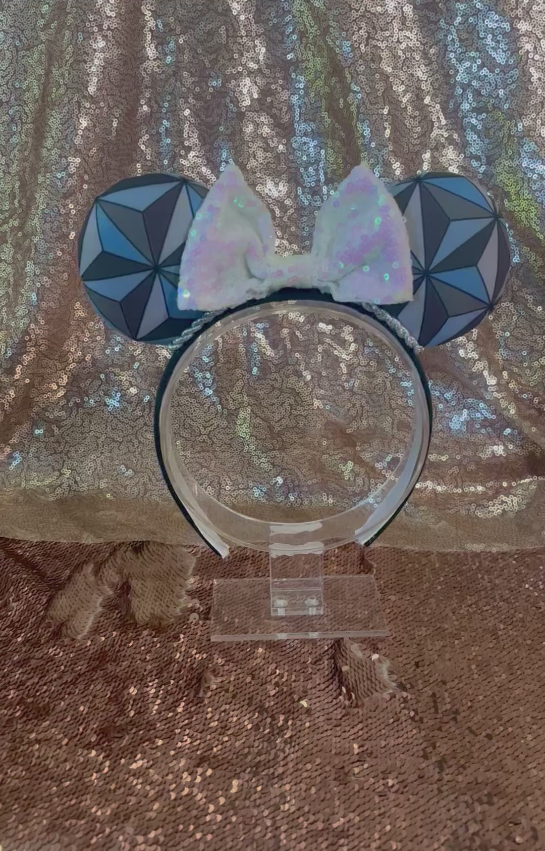 Handmade and ready to ship Mouse ear headband with a geometric design inspired by Spaceship Earth ride and a white iridescent bow on a universal sized black headband.