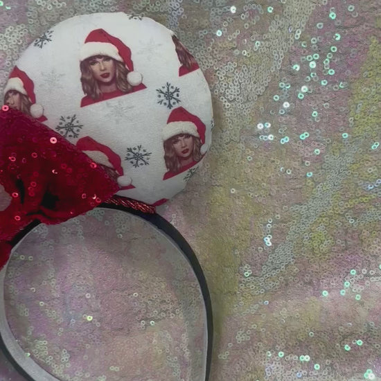 Mouse ear headband with red bow and character print on a glittery background