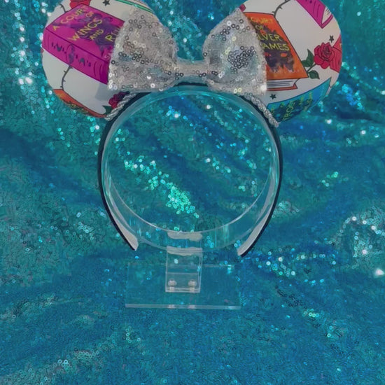 Handmade and ready to ship custom and unique ears that have images from the books on the mouse ears front and back. Silver twisted trim is along the inner ears with a silver sequin bow on a black poly cotton universal sized headband.